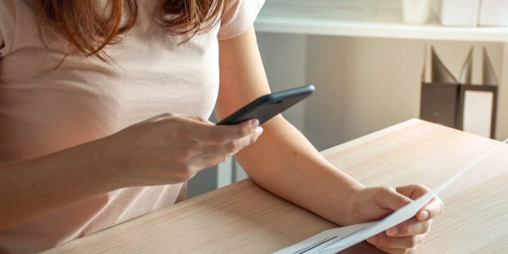 A woman uses a smartphone to send and receive money. financial app concept